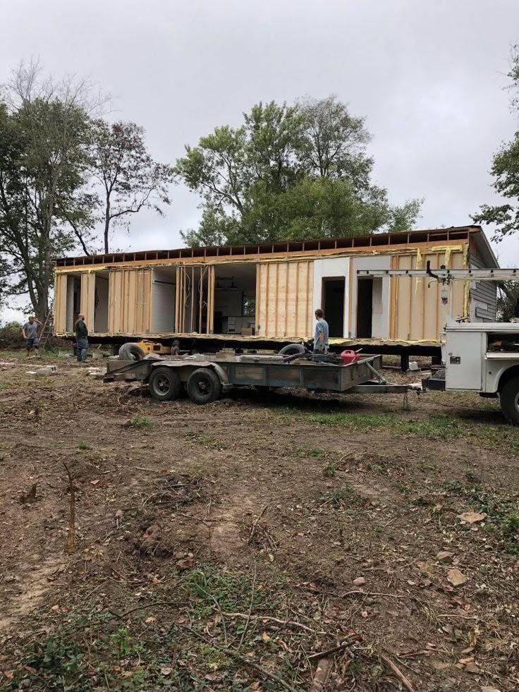 Crew leveling and blocking a manufactured home