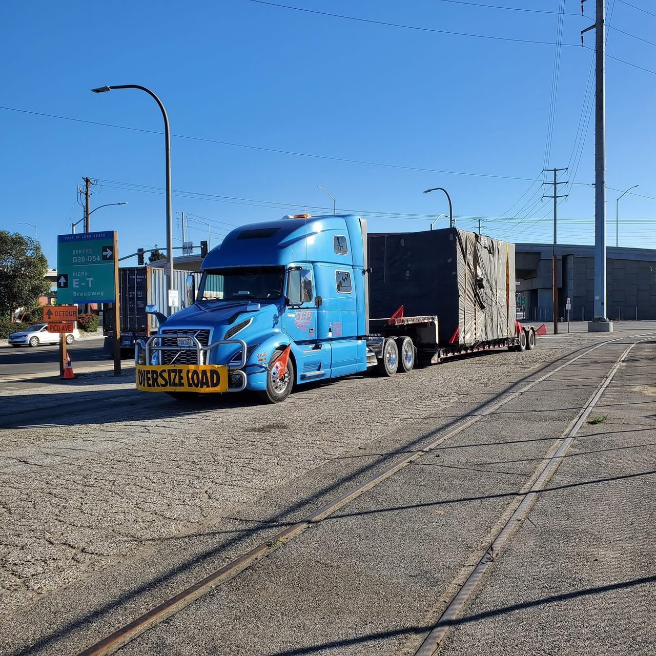 Manufactured home section being transported by truck